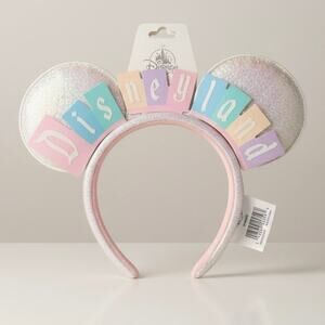 NWT Disney Resorts Pastel Disneyland Marquee Sparkling White Ear Headband 3-2026